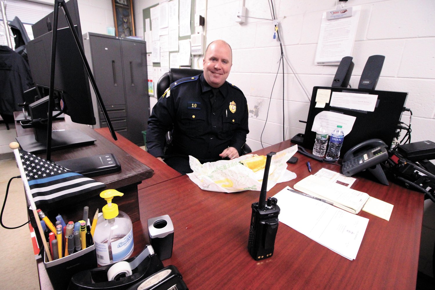 TIME FOR LUNCH:  Lt. McGee finds a place for a sandwich between his paperwork.